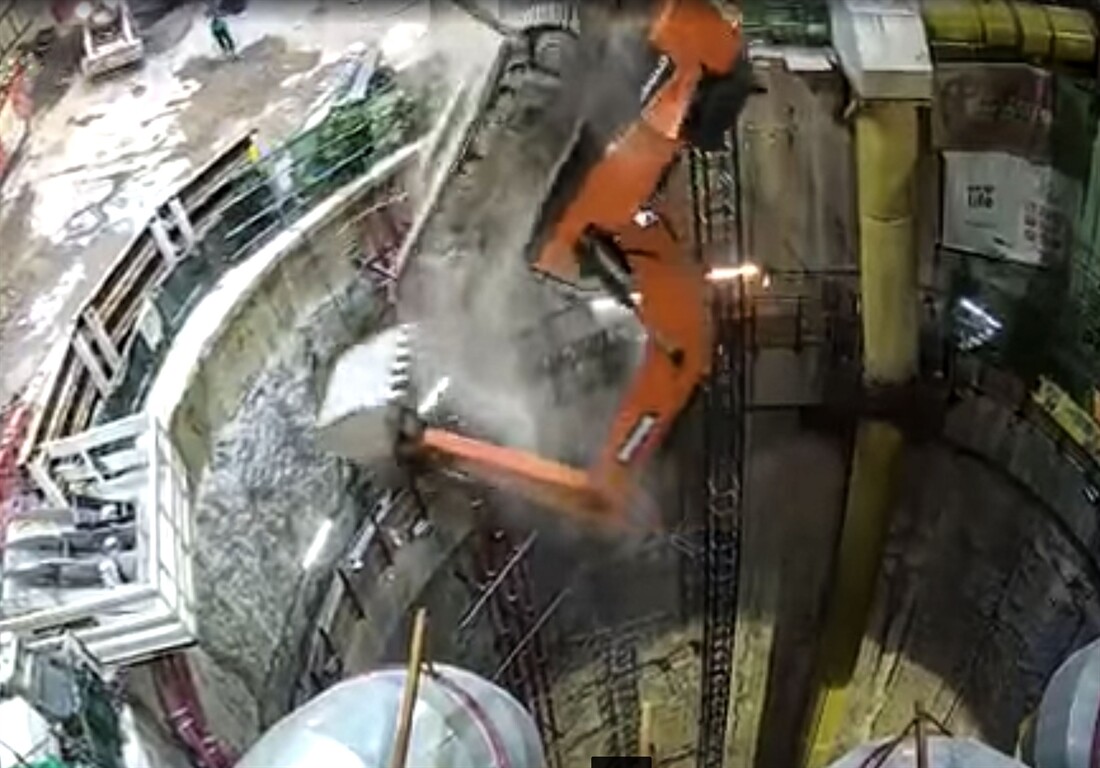Excavator falls down shaft