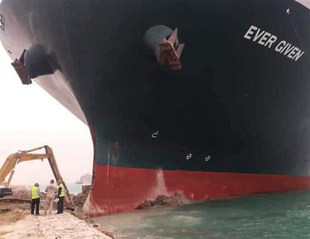 Digger attempts to free ship stuck in Suez Canal